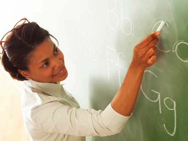 Teacher Writing Alphabet on Chalk Board 2003
